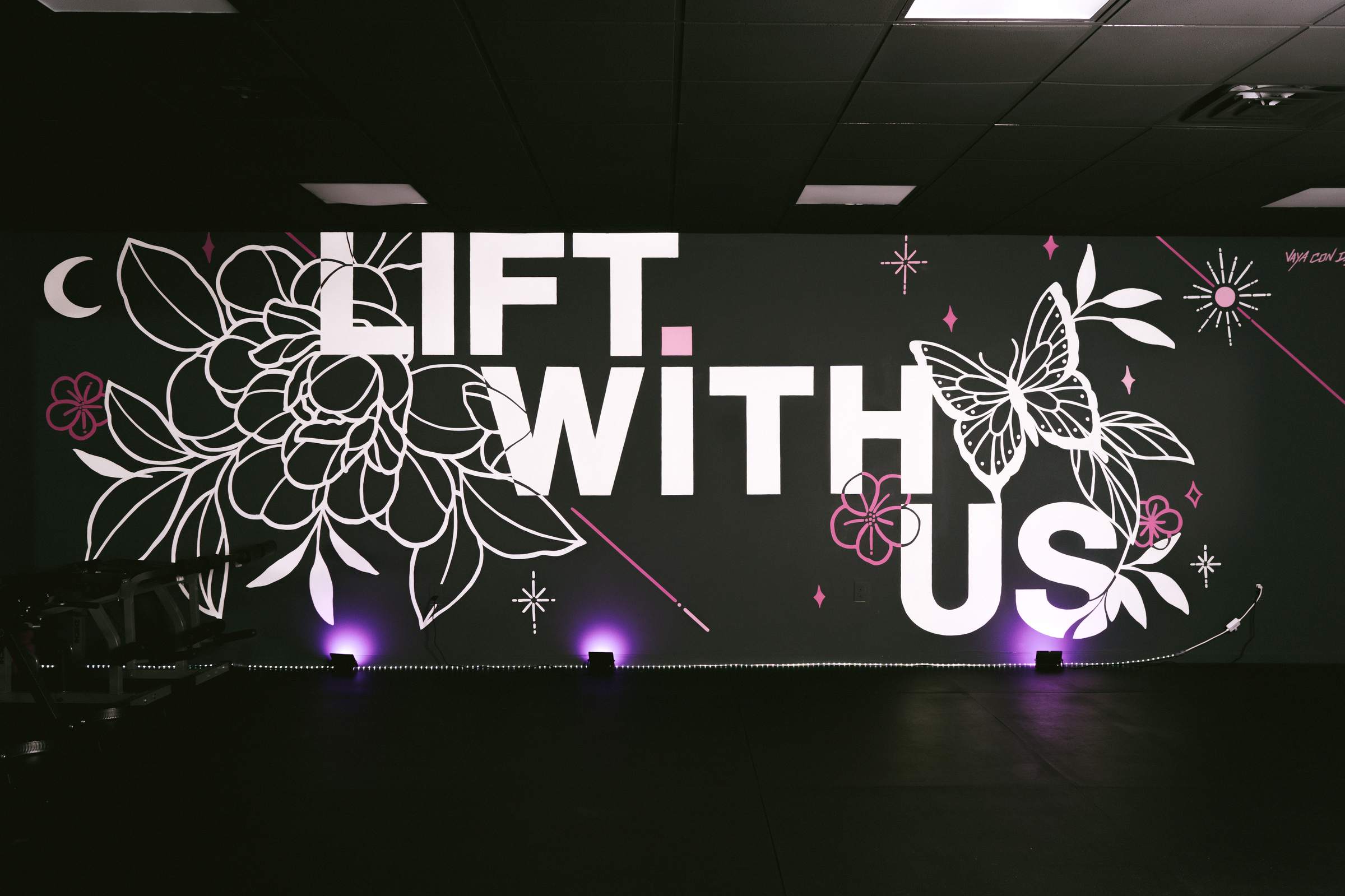 The hand-painted Lift With Us mural in the studio